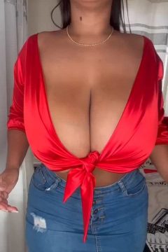 amateur girl with large breasts in braless red top